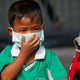This little cutie’s covering his face to protect himself from air pollution. :(